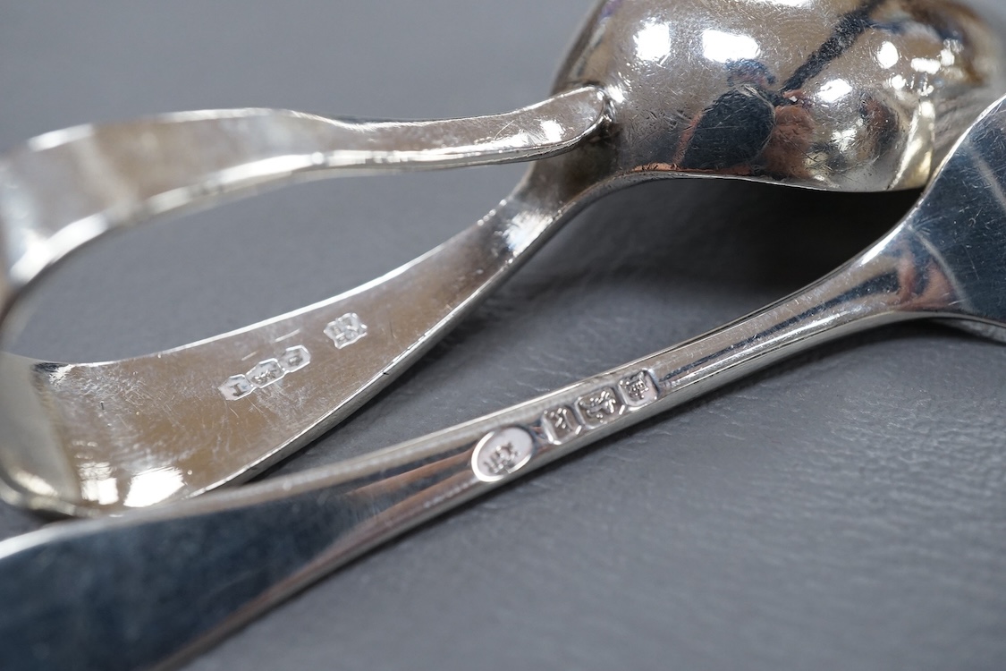 A George V silver mounted hand mirror, a silver spoons and pusher, a silver christening fork and spoon and a silver plated tea caddy.